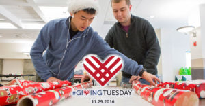 2 male students wrap Christmas Presents for Giving Tuesday