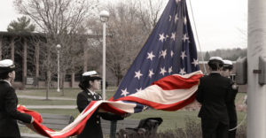 MVCC military sstudents raising an american flag.
