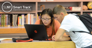 female and male student in library on laptop with Smart Track logo overhead