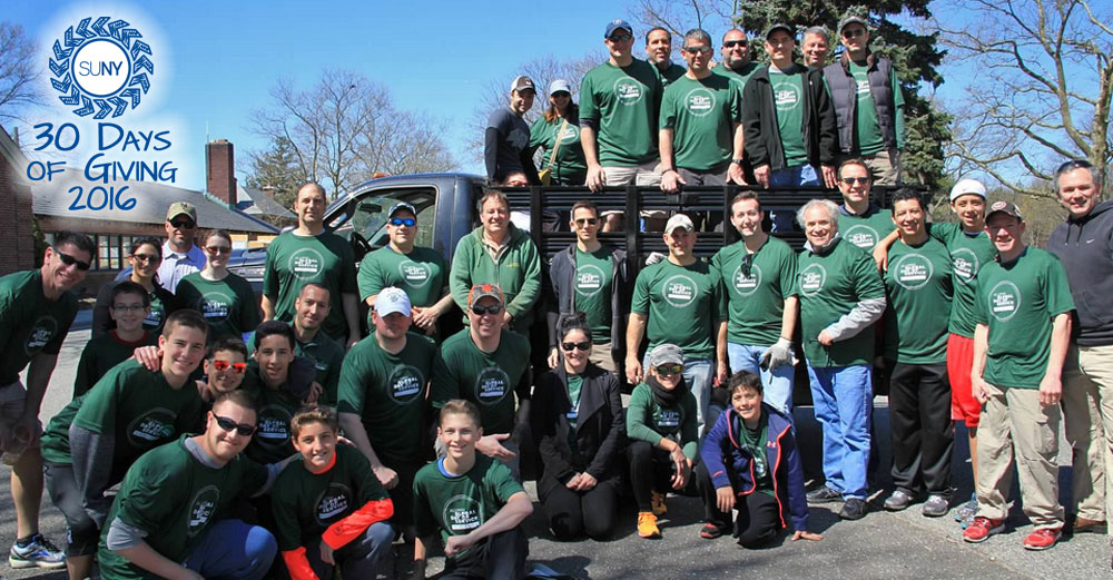 Volunteer alumni from Binghamton University pose in front of truck at Long Island National Cemetery in Farmingdale as part of the Hope for the Warriors project.