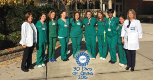 Farmingdale State College nurse students stand together outside with 30 Days of Giving logo.