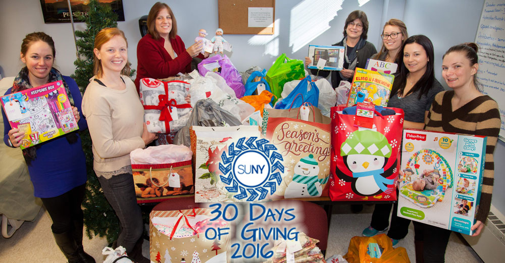 Ulster County Community College studetns and staff stand with bags of gifts gathered during Angel Tree program.