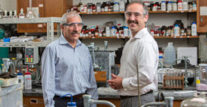 Wayne Jones and Bill Bernier, of Binghamton University, standing in a school lab.