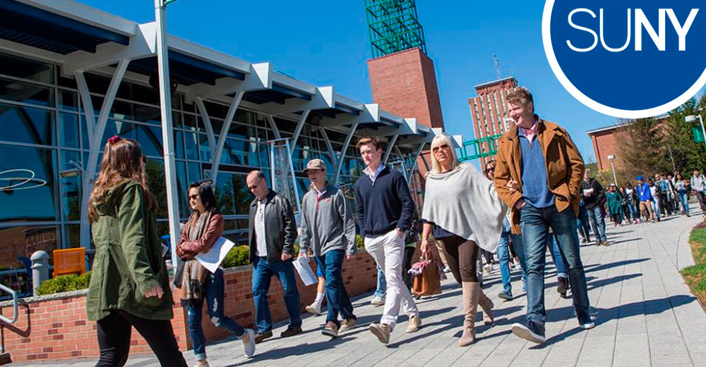Students and parents walking outside during a tour of the Binghamton University campus. 
