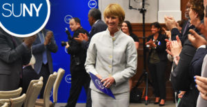 Kristina M Johnson walks to the podium after being appointed the 13th Chancellor of SUNY