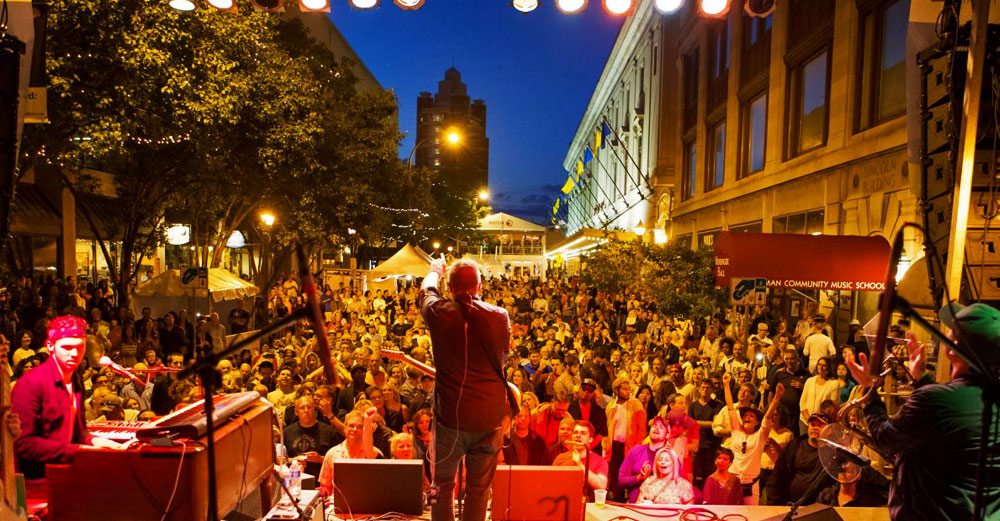 A view of the Rochester Jazz fest from the stage as a band performers for hundreds of fans at night. 