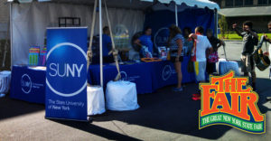 SAttendees meet with SUNY Staff at the SUNY Botth at the 2016 New York State Fair.