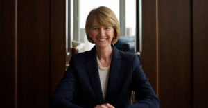 Dr. Kristina M. Johnson, chancellor of SUNY, smiles while seated at a conference table.