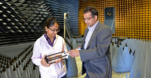 SUNY Oswego's Patanjali Parimi, director of the Advanced Wireless Systems Research Center, stands with female researcher.