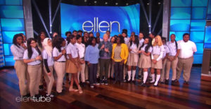 Ellen DeGeneres stands with students from Summit Academy on her set stage.