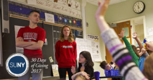 Students from SUNY Oneonta teach elementary school children in their classroom.