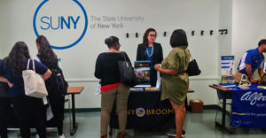 Students talk to college representatives at the SUNY-EOC Community College Fair in Brooklyn.
