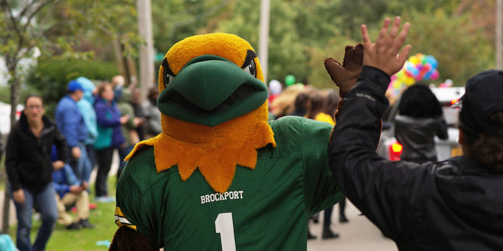 College at Brockport mascot Ellsworth Eagle gives a high five.