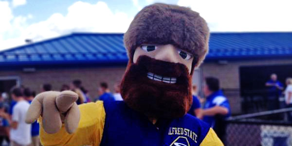 Alfred State mascot Orvis the Pioneer outside pointing at camera. 