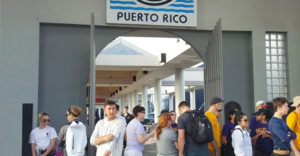 SUNY students stand on a pier after reaching the island of Puerto Rico for their recovery mission.