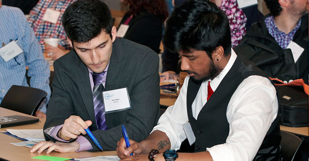 Entrepreneurs work together at a table at a SUNY ZAP event.