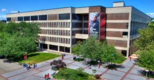 Stony Brook University campus building aerial photo with students walking outside.