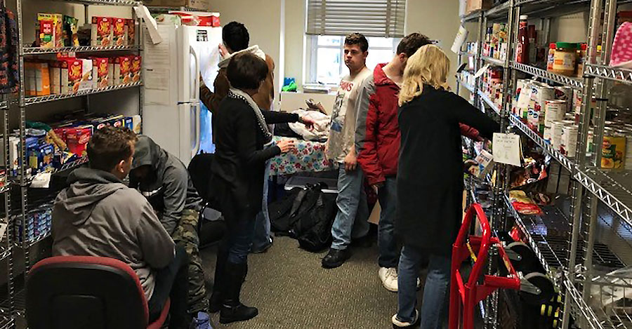 Students look through items on shelves in a campus food bank.