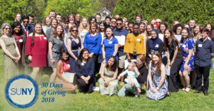 First-year interns from SUNY New Paltz pose outside with mentors.