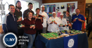 Niagara County Community College culinary students behind a table of pet treats they created.