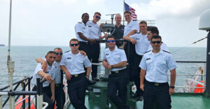 Maritime College cadets stand outside on the deck of the Empire State VI training ship during the summer at sea 2019.