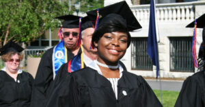African-american female graduate in cap and gown.