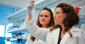 Two female students in UBuffalo medical research lab.
