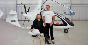 Kristen Steinhardt and Robert Lutz in a warehouse in front of a gyroplane.