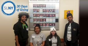 Mohawk Valley Community College students along a wall at an area NICU center
