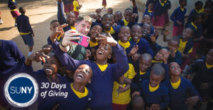 UB student Dylan McCaffrey takes a selfie with local schoolchildren during a visit to Tanzania in 2017. Photo: Douglas Levere