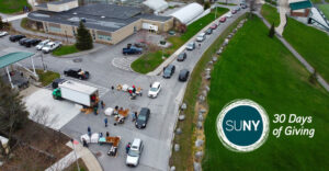 Cars line up for a dairy food drive at SUNY Morrisville