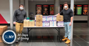 Pano Sourlis (left) and Vincent DeStefano (right) with donations from local school districts that they delivered to the Wang Center for Stony Brook University Hospital’s frontline workers