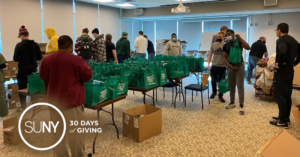 Students and Staff packing food bags at Hudson Valley Community College.