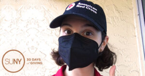 SUNY ESF student Madeline Clark in American Red Cross hat and black facemask