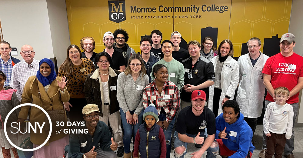 Monroe Community College students pose for a picture with are refugees.