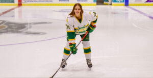 Simone Bednarik in full hockey gear poses for a picture on the SUNY Oswego rink.