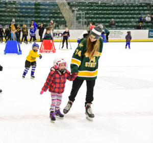 Simone Bednarik skates with kids at the SUNY Oswego ice rink.