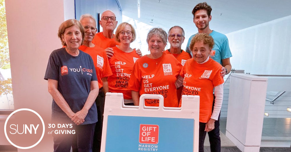 A SUNY New Paltz student stands with people who have been helped by the Gift of Life program of bone marrow donor matches.