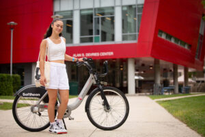 Stony Brook University student with an SBU bike