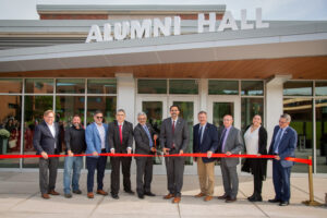 Chancellor King, President Cardelle, and SUNY Oneonta leaders cut ribbon to SUNY Oneonta's renovated Alumni Hall