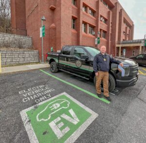 SUNY ESF's Bob Dugan poses in front of new EV truck