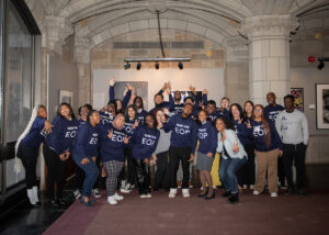 A group of students strike funny poses wearing blue EOP sweatshirts