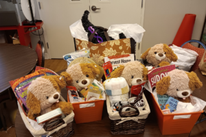 Gift baskets filled with various items sit on a table