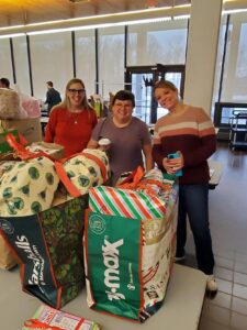 SUNY Oneonta staff pose with completed gift bags