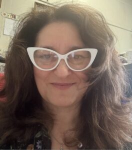 Headshot of Professor Rena Orman with classroom walls in the background
